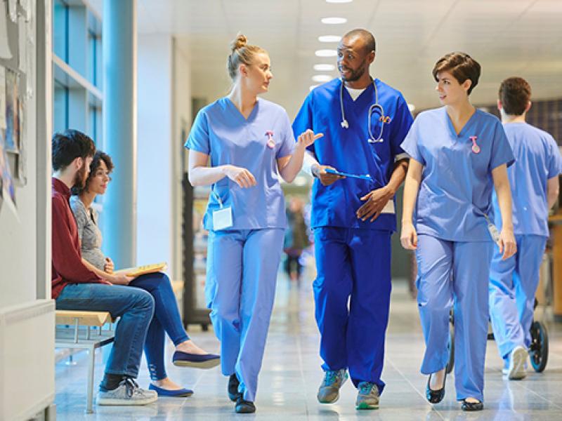 group of medical professionals walking down a hallway